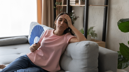 Woman on couch sweating