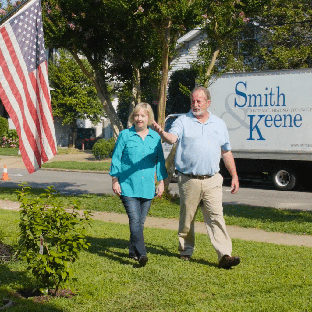 Service Tech and Customer Walking in front yard