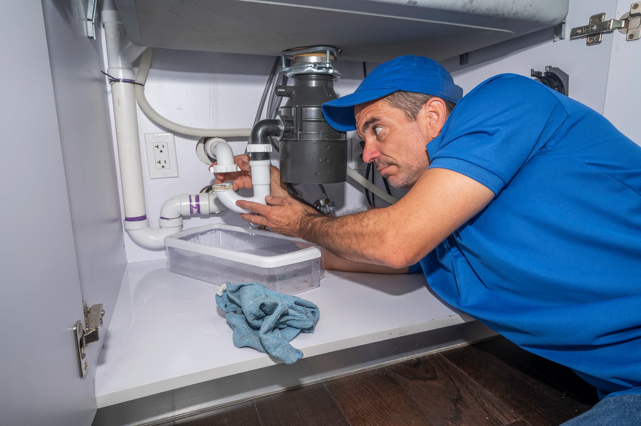 Plumber fixing sink